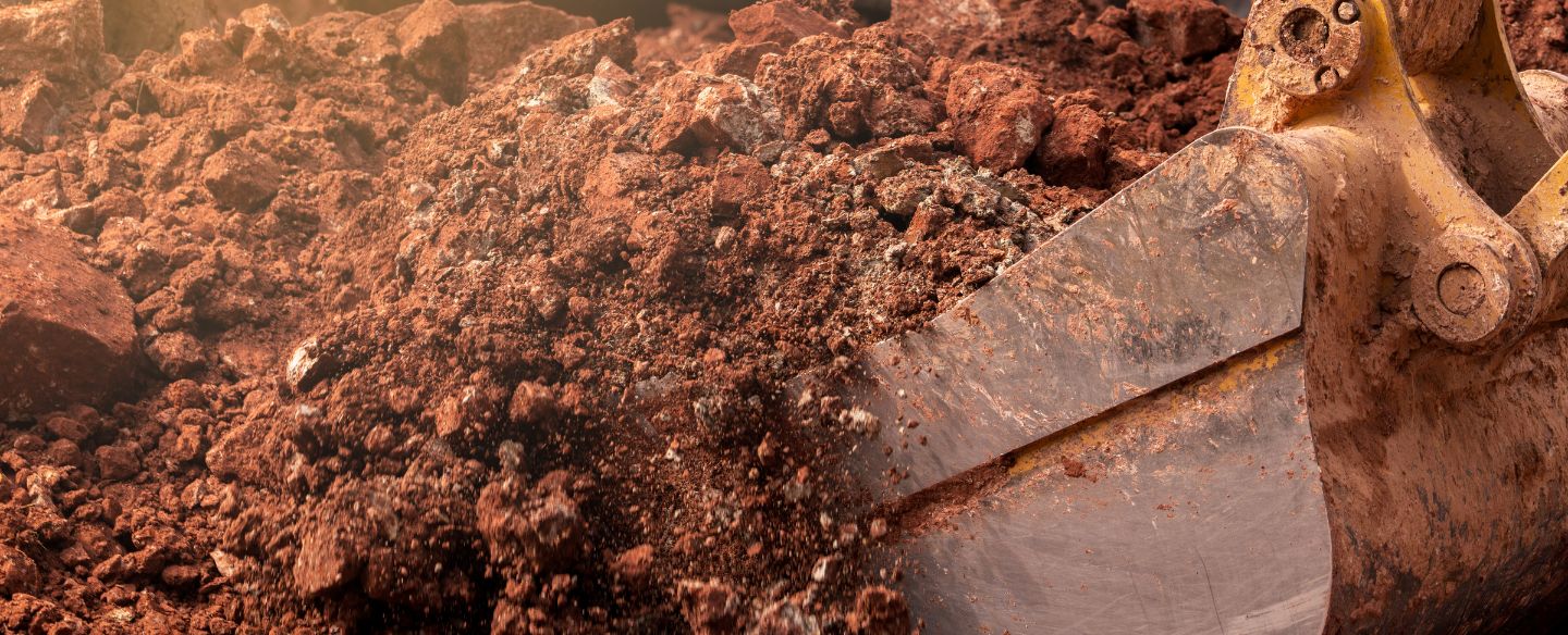 close up of excavator digging soil orange tx